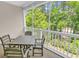 Enjoy outdoor living on this screened-in porch featuring a dining table and views of lush trees at 6015 Catalina Dr. # 733, North Myrtle Beach, SC 29582