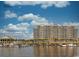Picturesque waterfront view of the high-rise condo building, marina, and boats under a partly cloudy sky at 6015 Catalina Dr. # 733, North Myrtle Beach, SC 29582
