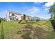 Large backyard features a play set, black fence, and ample space for entertaining at 625 Heritage Downs Dr., Conway, SC 29526