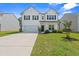 Charming two-story home with a well-maintained lawn, attached garage and inviting front porch at 625 Heritage Downs Dr., Conway, SC 29526