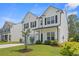 Charming two-story home with a well-maintained lawn, attached garage and inviting front porch at 625 Heritage Downs Dr., Conway, SC 29526