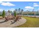 Community firepit with comfortable Adirondack chairs, ideal for gathering and enjoying the outdoors at 625 Heritage Downs Dr., Conway, SC 29526