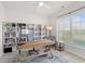 Bright home office with custom built-in bookshelves, large window, and stylish desk area at 625 Heritage Downs Dr., Conway, SC 29526
