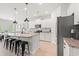 Well lit kitchen features a granite island with seating, stainless appliances, and white cabinets at 625 Heritage Downs Dr., Conway, SC 29526
