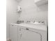 Functional laundry room features a washer, dryer, and shelving for storage and supplies at 625 Heritage Downs Dr., Conway, SC 29526