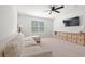 Relaxing living room featuring a sectional sofa, ceiling fan, window, TV, and neutral carpet at 625 Heritage Downs Dr., Conway, SC 29526