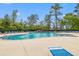 Inviting community pool with ample lounge chairs for relaxing poolside on a sunny day at 625 Heritage Downs Dr., Conway, SC 29526