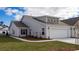Charming single-Gathering home featuring a two-car garage, well-manicured lawn, and a classic light-gray facade at 7001 River Bridge Ct, Myrtle Beach, SC 29579
