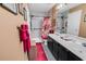 Bathroom boasts double sinks, a decorative red shower curtain, and tiled shower at 701 Wilshire Ln. # 0, Murrells Inlet, SC 29576