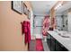 Bathroom boasts double sinks, a decorative red shower curtain, and tiled shower at 701 Wilshire Ln. # 0, Murrells Inlet, SC 29576