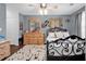 Cozy bedroom with elegant iron bed frame, dresser with mirror, and ceiling fan at 701 Wilshire Ln. # 0, Murrells Inlet, SC 29576