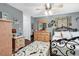 Cozy bedroom with elegant iron bed frame, dresser with mirror, and ceiling fan at 701 Wilshire Ln. # 0, Murrells Inlet, SC 29576