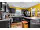 Bright eat-in kitchen with black appliances, yellow walls, and a butcher block island at 701 Wilshire Ln. # 0, Murrells Inlet, SC 29576