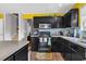 Bright kitchen with black appliances, tile backsplash, and warm yellow walls at 701 Wilshire Ln. # 0, Murrells Inlet, SC 29576