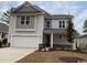 Charming two-story home with light-grey siding, well-manicured lawn and a two car attached garage at 731 Rupert Dr, Conway, SC 29526