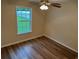 Bright bedroom featuring modern ceiling fan, window, and wood-look flooring at 753 Bucklin Loop, Myrtle Beach, SC 29579