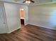 Bedroom featuring a ceiling fan and wood-look flooring, leading to the bathroom at 753 Bucklin Loop, Myrtle Beach, SC 29579