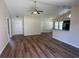 Open concept living room with wood floors, ceiling fan, and view of the kitchen at 753 Bucklin Loop, Myrtle Beach, SC 29579