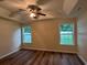Spacious main bedroom with wood floors, ceiling fan, and natural light from two windows at 753 Bucklin Loop, Myrtle Beach, SC 29579