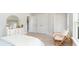 Bedroom featuring light-colored walls, a rattan chair, and a decorative dresser at 768 Choctaw Dr., Conway, SC 29526