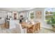 Stylish dining area featuring a wooden table, woven chairs, and a view into the kitchen at 768 Choctaw Dr., Conway, SC 29526