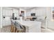 Bright kitchen boasts white cabinets, stainless steel appliances, and quartz counters with seating at 768 Choctaw Dr., Conway, SC 29526