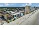 Aerial view of beachfront condos and houses with sparkling swimming pools located along a pristine sandy beach at 806 N Waccamaw Dr. # 304, Garden City Beach, SC 29576