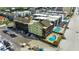 Aerial view of condo with a uniquely shaped swimming pool, wooden deck, and ample parking spaces at 806 N Waccamaw Dr. # 304, Garden City Beach, SC 29576