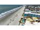 Aerial view showing the beach, pier, and condos next to a body of water on a sunny day at 806 N Waccamaw Dr. # 304, Garden City Beach, SC 29576