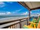Enjoy ocean views from this private balcony featuring colorful Adirondack chairs and beach access at 806 N Waccamaw Dr. # 304, Garden City Beach, SC 29576