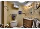 Bathroom with a modern vanity, mirror, a white toilet, and neutral decor at 806 N Waccamaw Dr. # 304, Garden City Beach, SC 29576