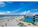Expansive beach view from the property showcasing the coastline, blue skies, and nearby buildings at 806 N Waccamaw Dr. # 304, Garden City Beach, SC 29576