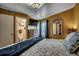 Bright bedroom featuring a bathroom, TV, a comfy bed with a blue blanket, and a wicker mirror at 806 N Waccamaw Dr. # 304, Garden City Beach, SC 29576