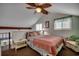 Bedroom with sloped ceilings, a ceiling fan, and a small sitting area at 806 N Waccamaw Dr. # 304, Garden City Beach, SC 29576