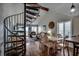 Bright dining area featuring luxury vinyl plank flooring and a spiral staircase at 806 N Waccamaw Dr. # 304, Garden City Beach, SC 29576