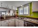 Open kitchen with a breakfast bar, with convenient access to the living and dining areas at 806 N Waccamaw Dr. # 304, Garden City Beach, SC 29576