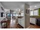 Open concept kitchen with breakfast bar, spiral staircase, and luxury vinyl plank flooring at 806 N Waccamaw Dr. # 304, Garden City Beach, SC 29576