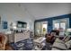 Bright living room boasts a vaulted ceiling, stylish decor, and balcony access with ocean view at 806 N Waccamaw Dr. # 304, Garden City Beach, SC 29576