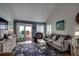 Cozy living room features stylish coastal decor and a sliding door leading to a private balcony at 806 N Waccamaw Dr. # 304, Garden City Beach, SC 29576