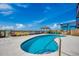 Close-up of a kidney-shaped swimming pool with lounge chairs and an outdoor wooden structure at 806 N Waccamaw Dr. # 304, Garden City Beach, SC 29576