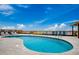 Close-up of a kidney-shaped swimming pool surrounded by lounge chairs and with a shelter to the side at 806 N Waccamaw Dr. # 304, Garden City Beach, SC 29576