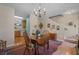 Cozy dining area with wood table, chandelier, and access to the kitchen, creating an inviting space for meals at 816 Barn Owl Ct. # 816, Myrtle Beach, SC 29579