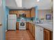 Bright kitchen with appliances, wood cabinets, plenty of counter space, and an open view into the living room at 816 Barn Owl Ct. # 816, Myrtle Beach, SC 29579