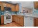 Efficient kitchen featuring stainless steel appliances, wood cabinetry, and an open layout for easy access at 816 Barn Owl Ct. # 816, Myrtle Beach, SC 29579
