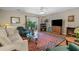 Inviting living room features hardwood floors, an area rug, a ceiling fan and access to the outdoor deck at 816 Barn Owl Ct. # 816, Myrtle Beach, SC 29579