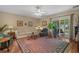 Bright living room with hardwood floors, an area rug, and sliding glass doors to the outdoor deck at 816 Barn Owl Ct. # 816, Myrtle Beach, SC 29579