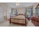 Comfortable main bedroom with a four poster bed, large windows, and classic decor at 816 Barn Owl Ct. # 816, Myrtle Beach, SC 29579