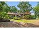 Lovely backyard with a screened-in porch, garden beds, and partial fence at 8506 Old Nichols Hwy., Nichols, SC 29581