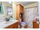 Functional bathroom featuring a vanity, toilet, and shower with floral accents, providing essential amenities at 8506 Old Nichols Hwy., Nichols, SC 29581