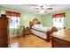 Comfortable bedroom with wood floors, ceiling fan, and a vintage-style wooden furniture set at 8506 Old Nichols Hwy., Nichols, SC 29581